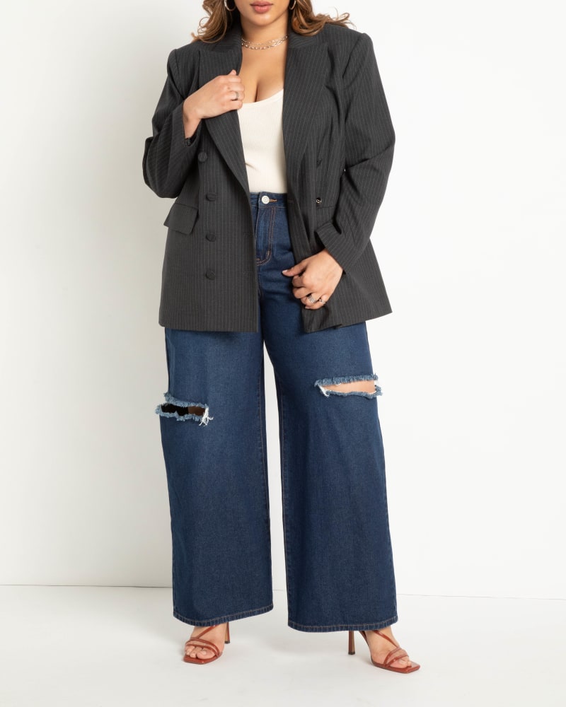 Front of a model wearing a size 24 Distressed Wide Leg Jeans in Medium True Blue Wash by ELOQUII. | dia_product_style_image_id:272764